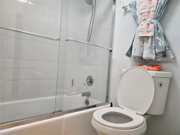 a bathroom with a toilet a sink and a mirror