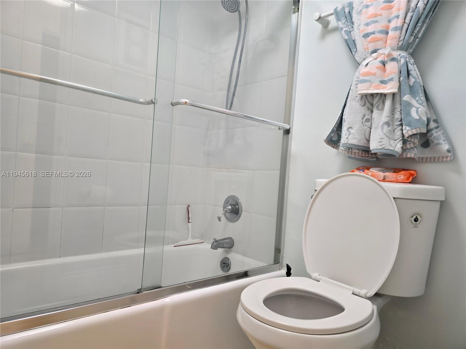 100 Lincoln Road, Unit 503 Miami Beach, FL 33139 - Photo 11 of 25 a bathroom with a toilet a sink and a mirror