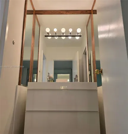 a view of a living room with a mirror and a chandelier