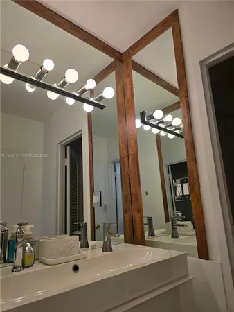 a bathroom with a sink vanity and a mirror