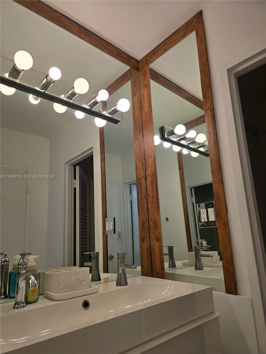100 Lincoln Road, Unit 503 Miami Beach, FL 33139 - Photo 13 of 25 a bathroom with a sink vanity and a mirror