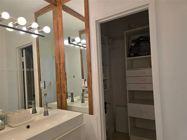 a bathroom with a double vanity sink and a mirror