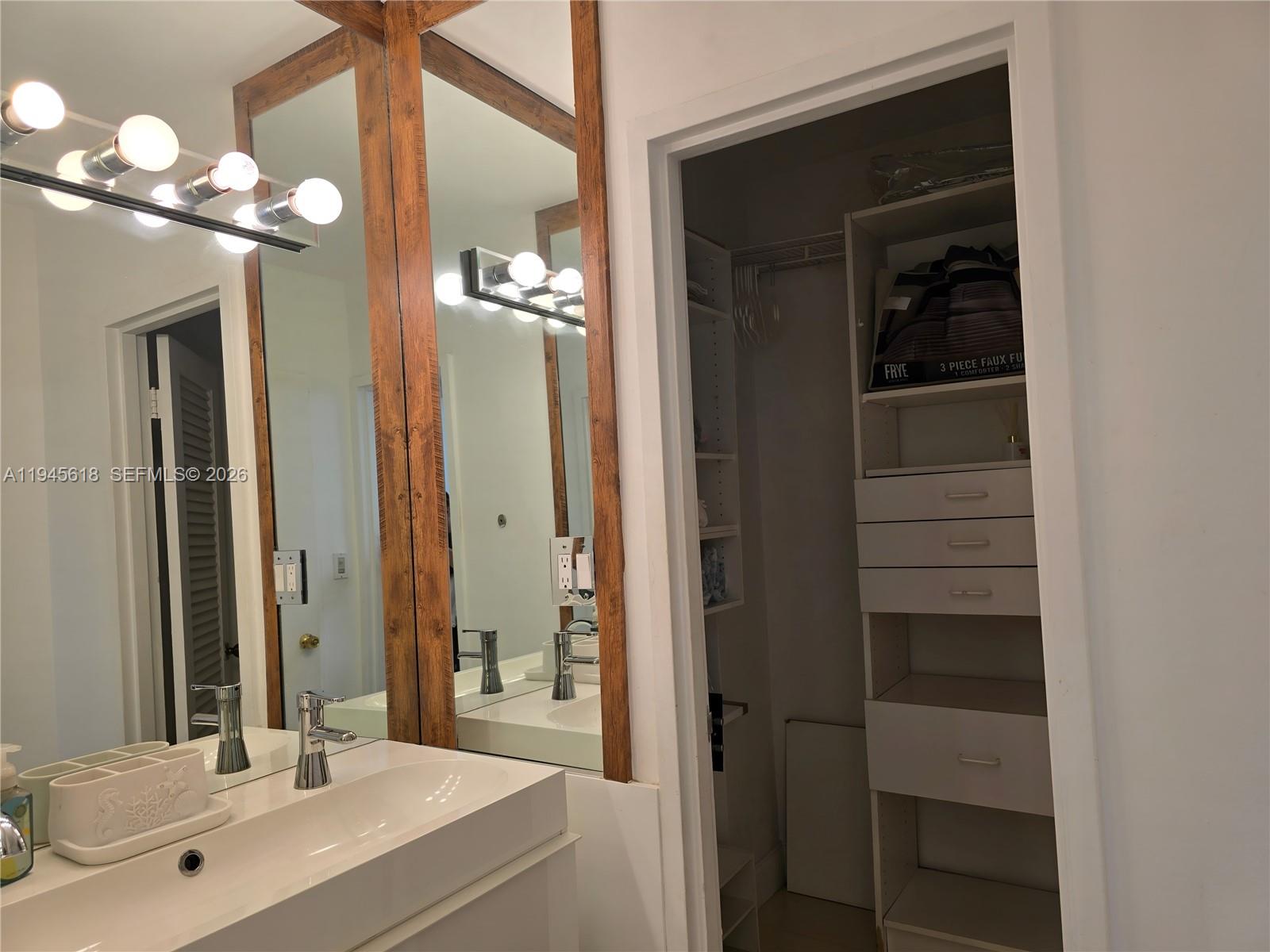 100 Lincoln Road, Unit 503 Miami Beach, FL 33139 - Photo 14 of 25 a bathroom with a double vanity sink and a mirror