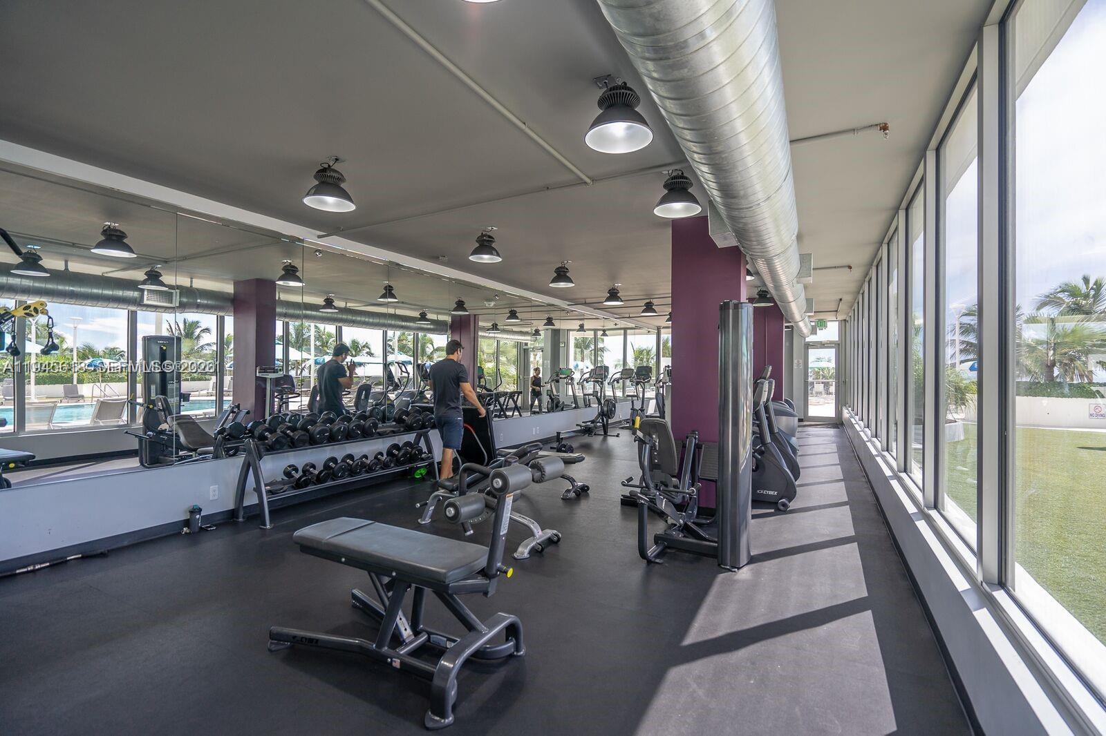 100 Lincoln Road, Unit 503 Miami Beach, FL 33139 - Photo 25 of 25 a room with gym equipment and large windows