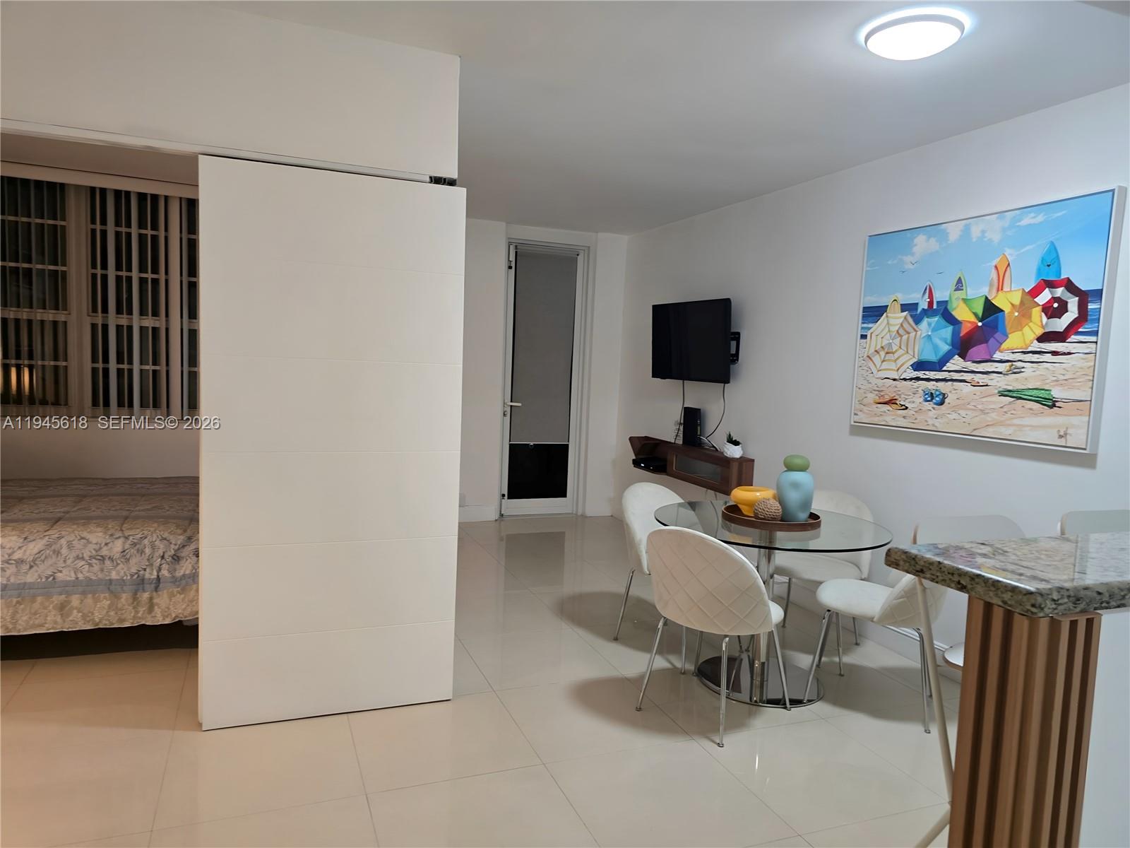 100 Lincoln Road, Unit 503 Miami Beach, FL 33139 - Photo 3 of 25 a living room with furniture and a flat screen tv