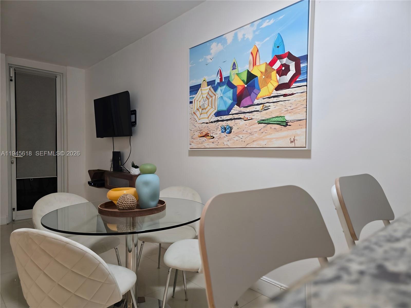 100 Lincoln Road, Unit 503 Miami Beach, FL 33139 - Photo 4 of 25 a workspace with furniture and painting on the wall