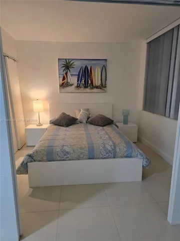 a bedroom with a large bed and a couch