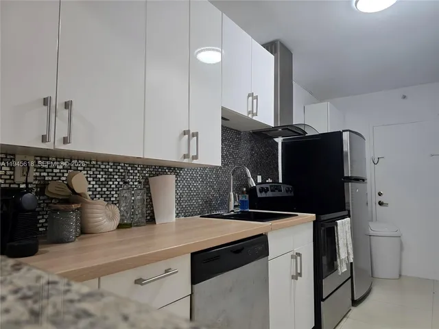 a kitchen with a sink and refrigerator