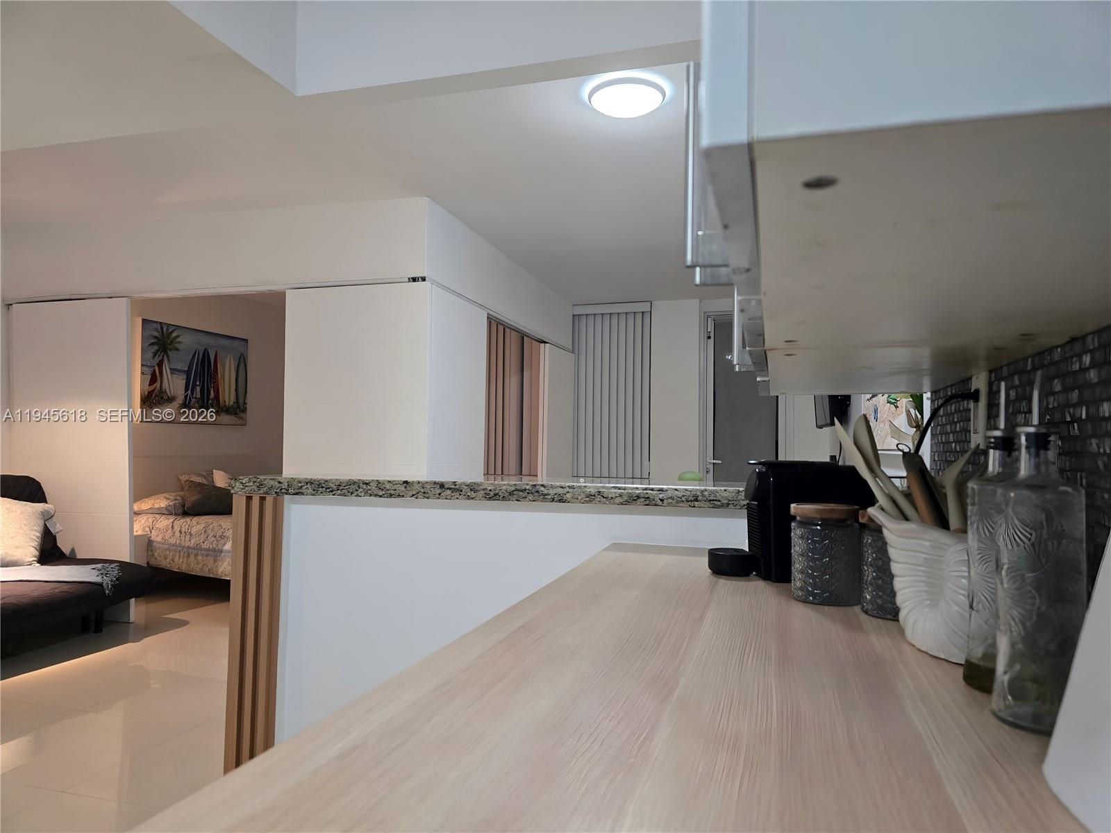 100 Lincoln Road, Unit 503 Miami Beach, FL 33139 - Photo 10 of 25 a view of a living room and a wooden floor