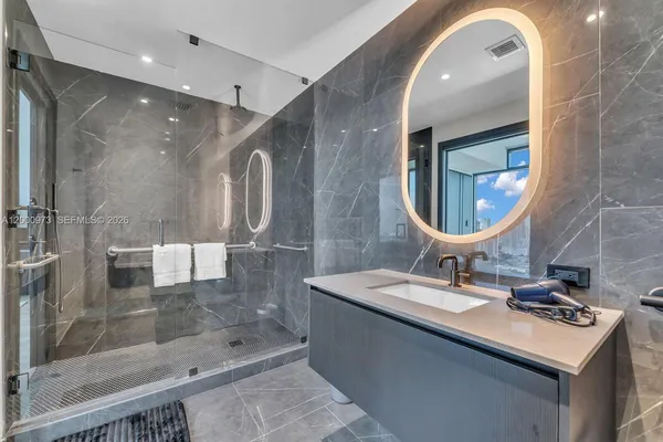 a large kitchen with stainless steel appliances a sink dishwasher a stove and cabinets