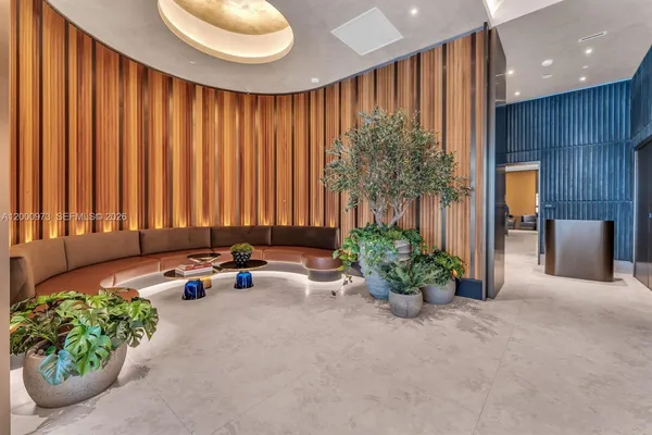 a living room with furniture and a potted plant
