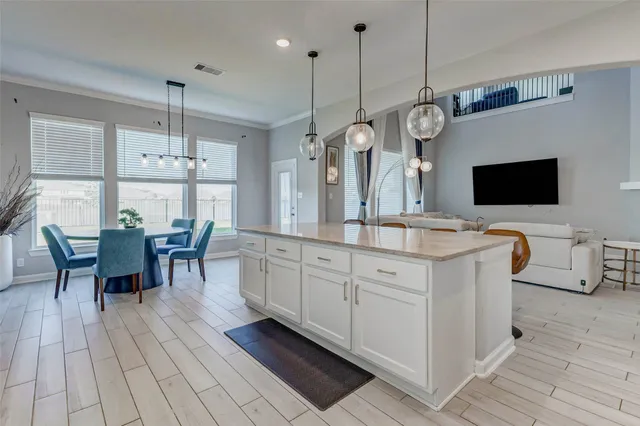 a large kitchen with a table and chairs in it