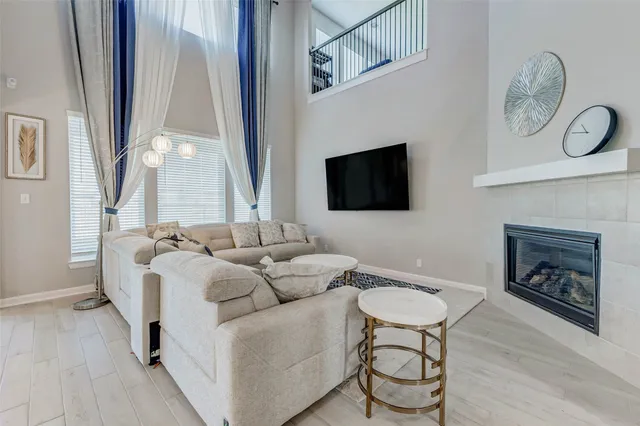 a living room with furniture a fireplace and a flat screen tv