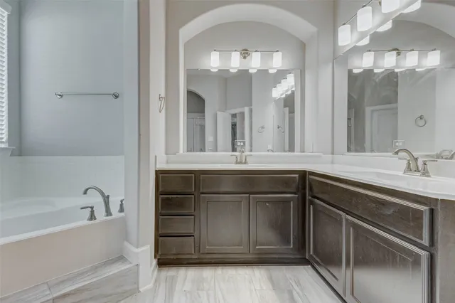 a bathroom with a sink vanity and mirror