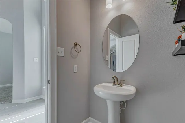 a bathroom with a sink a mirror and shower