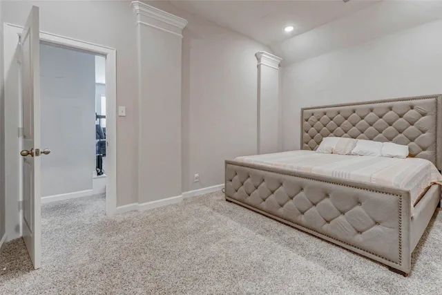 a spacious bedroom with a bed and a shower