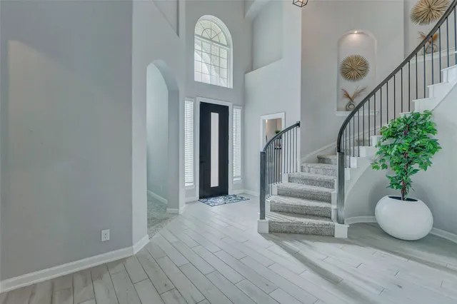 a view of entryway and hall with wooden floor