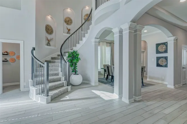 a view of entryway and hall with wooden floor