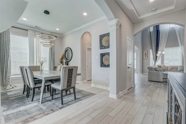 a view of a a dining room with furniture window and wooden floor