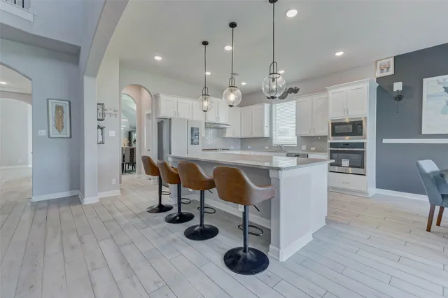 a large kitchen with lots of counter space and stainless steel appliances
