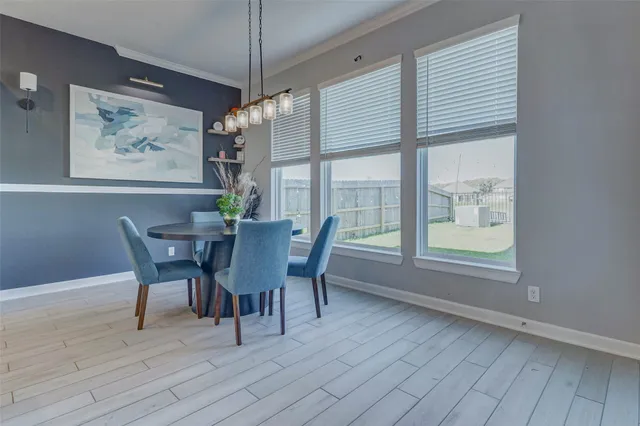a dining room with furniture a rug and wooden floor