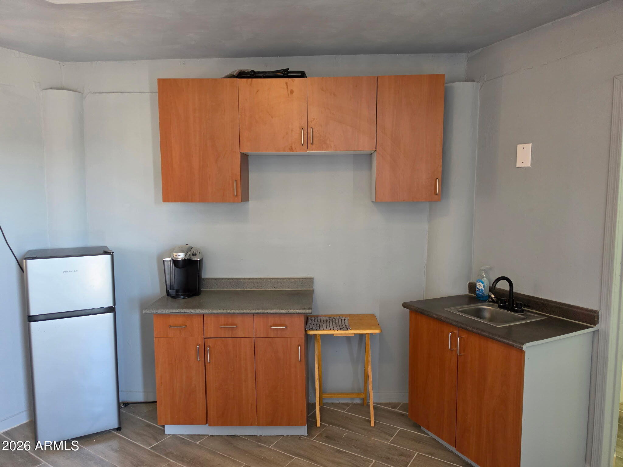 4333 West Carver Road, Unit B Laveen, AZ 85339 - Photo 4 of 6 a kitchen with a sink and a refrigerator