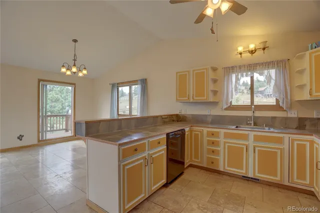 a open kitchen with stainless steel appliances granite countertop a stove and a sink