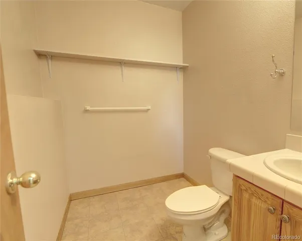a white toilet sitting next to a bathroom sink