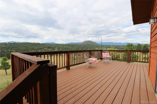 a view of wooden deck and a lake view