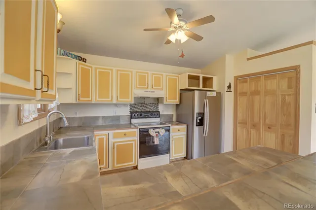 a kitchen with stainless steel appliances granite countertop a refrigerator and a sink