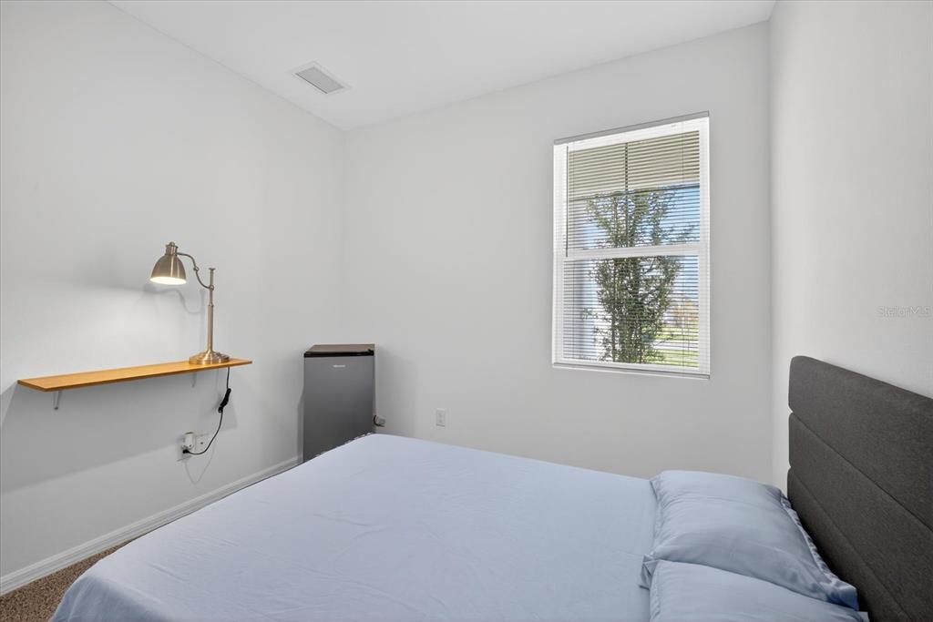 11883 Brighton Knoll Loop Riverview, FL 33579 - Photo 18 of 45 a bedroom with a bed and a window