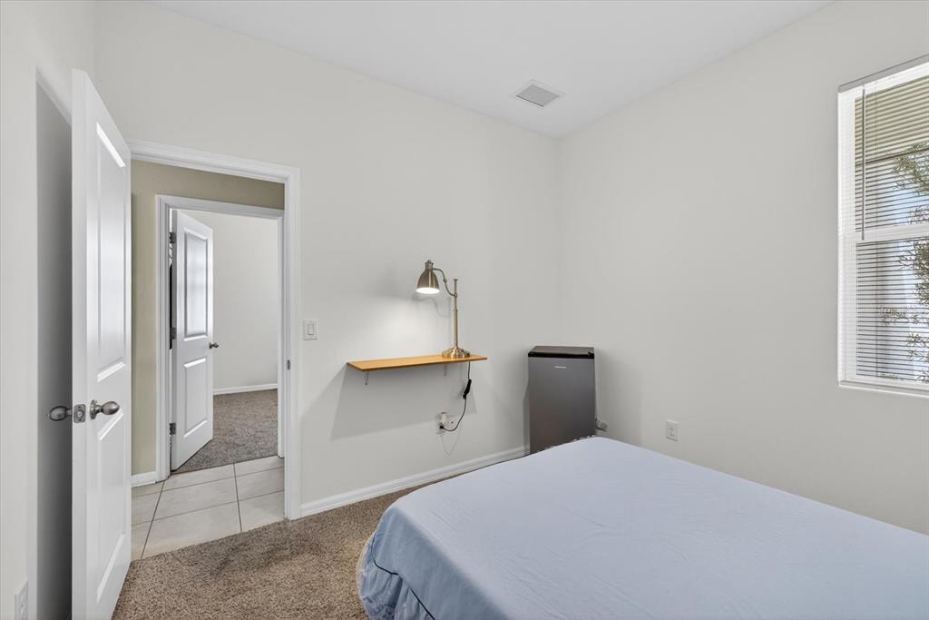 11883 Brighton Knoll Loop Riverview, FL 33579 - Photo 19 of 45 a bedroom with a bed and a window