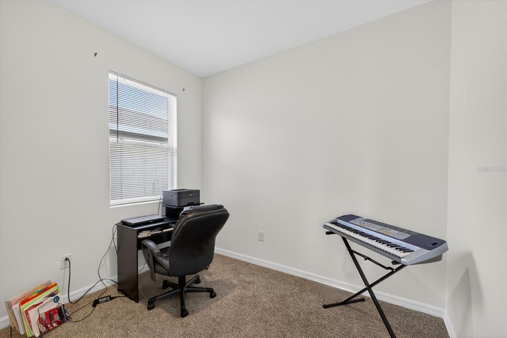 11883 Brighton Knoll Loop Riverview, FL 33579 - Photo 20 of 45 a room with a chair and potted plant