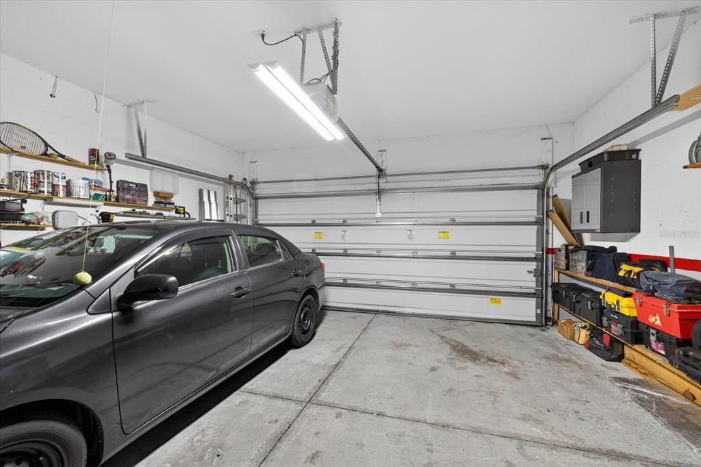 11883 Brighton Knoll Loop Riverview, FL 33579 - Photo 22 of 45 a view of parking garage with cars and other equipment