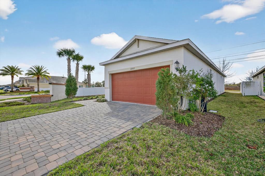 11883 Brighton Knoll Loop Riverview, FL 33579 - Photo 28 of 45 a front view of a house with garden