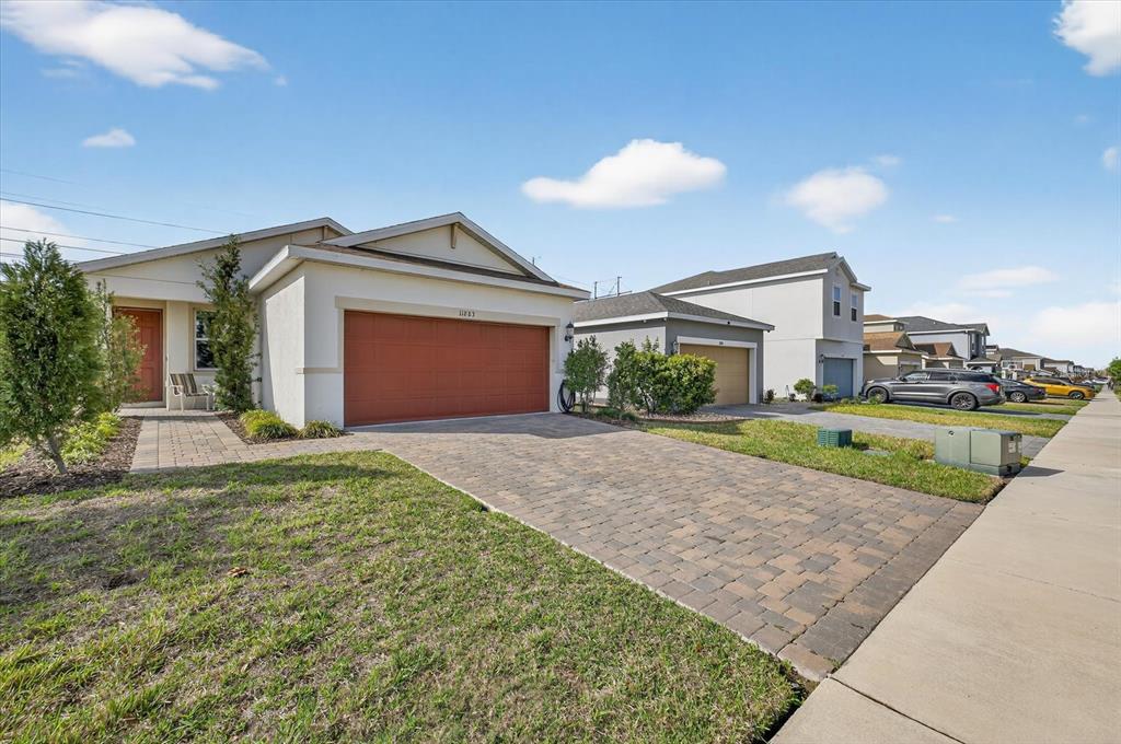 11883 Brighton Knoll Loop Riverview, FL 33579 - Photo 29 of 45 a front view of a house with a yard and garage