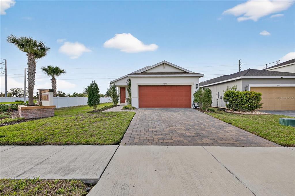11883 Brighton Knoll Loop Riverview, FL 33579 - Photo 44 of 45 a front view of a house with a yard and potted plants