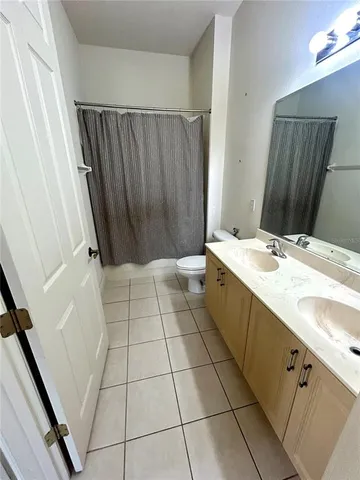 a kitchen with kitchen island granite countertop a refrigerator and a sink