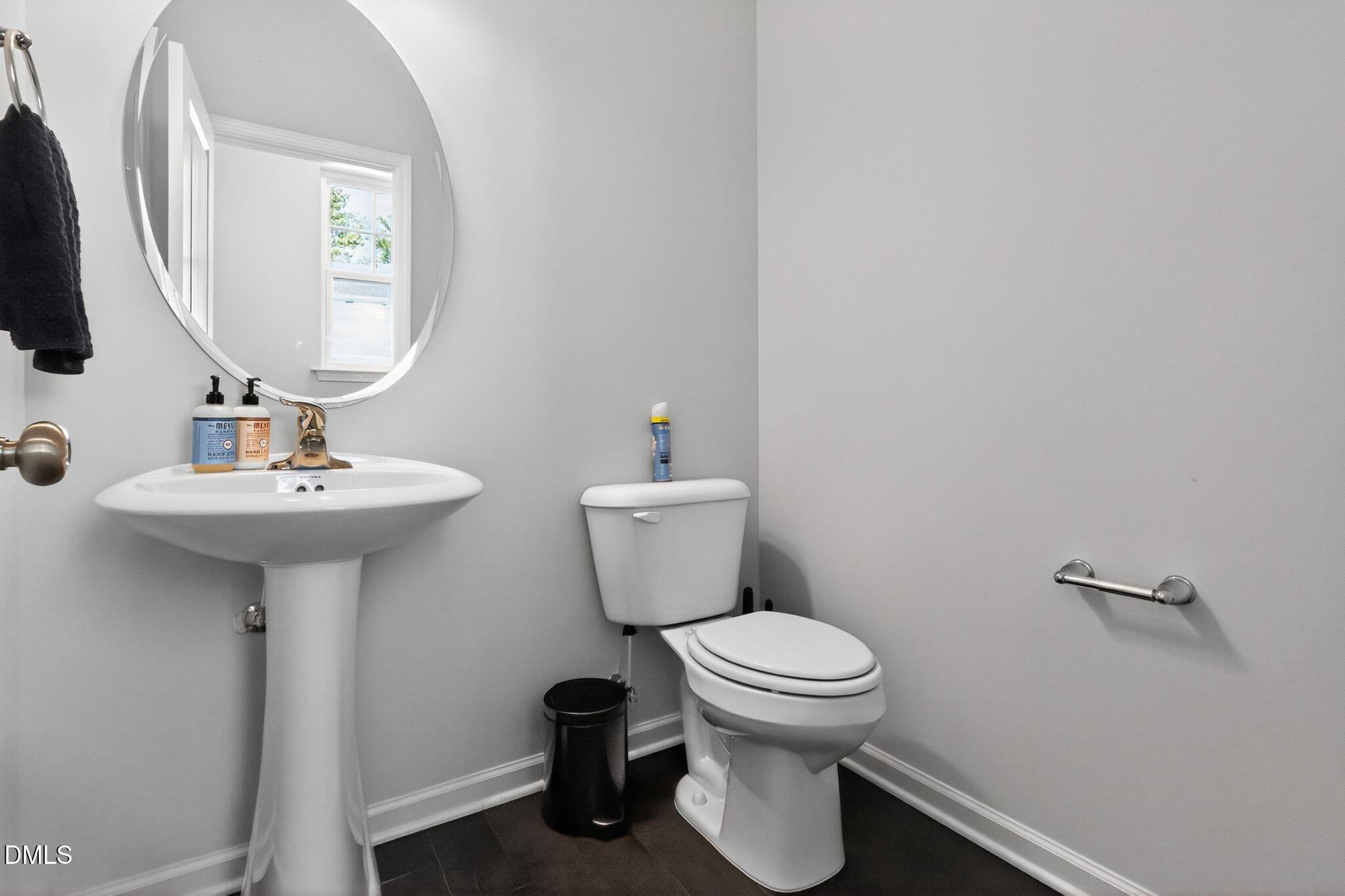 1118 Commack Drive Durham, NC 27703 - Photo 26 of 30 a bathroom with a sink toilet and a mirror