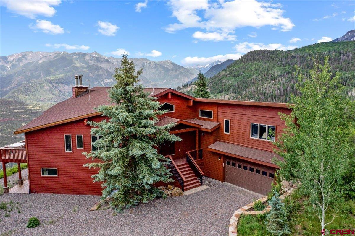 1600-2 Parcels) Elk Ridge Trail, Unit PARK ESTATES LOTS 4 AND 9 Ridgway, CO 81432 - Photo 1 of 39 a flower garden is sitting in front of a house