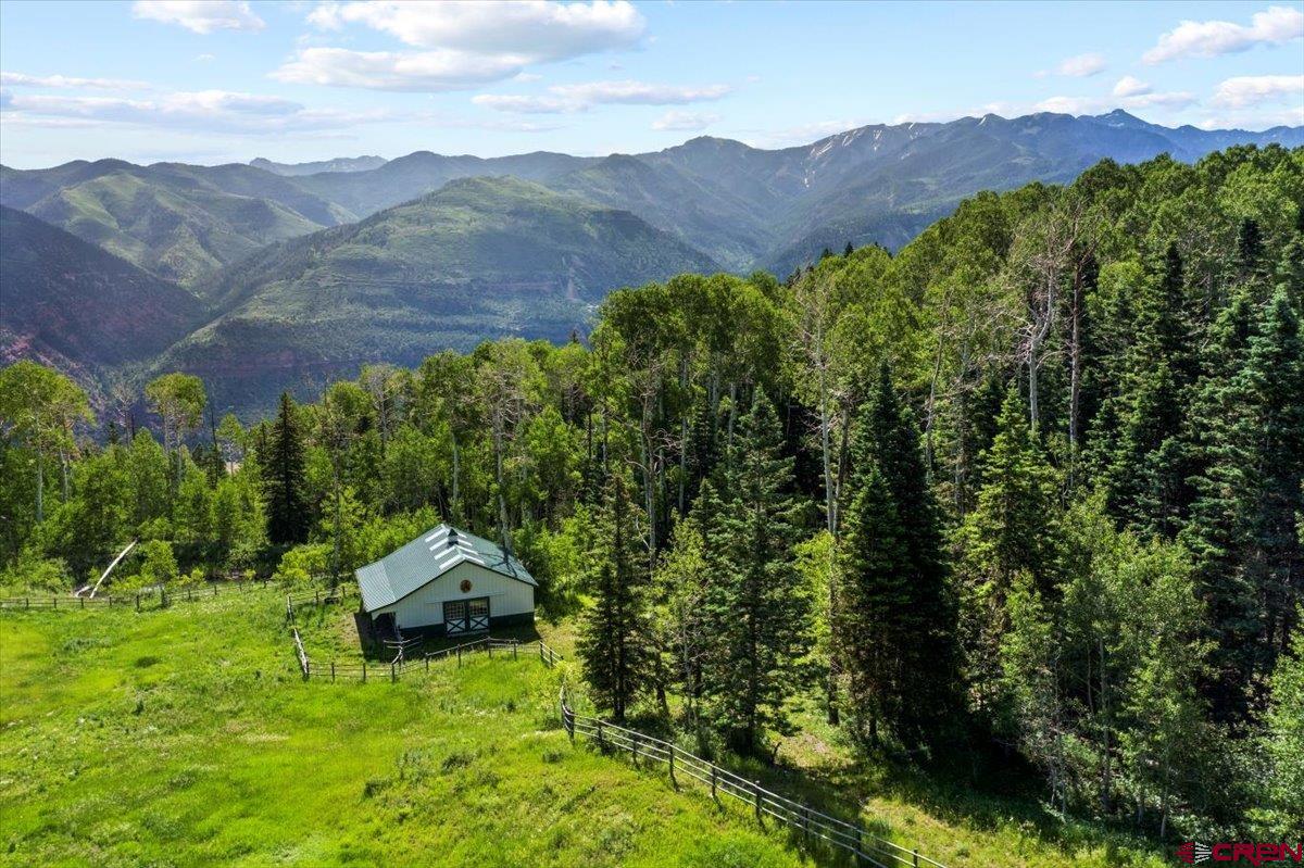 1600-2 Parcels) Elk Ridge Trail, Unit PARK ESTATES LOTS 4 AND 9 Ridgway, CO 81432 - Photo 31 of 39 a view of a lush green hillside and a houses