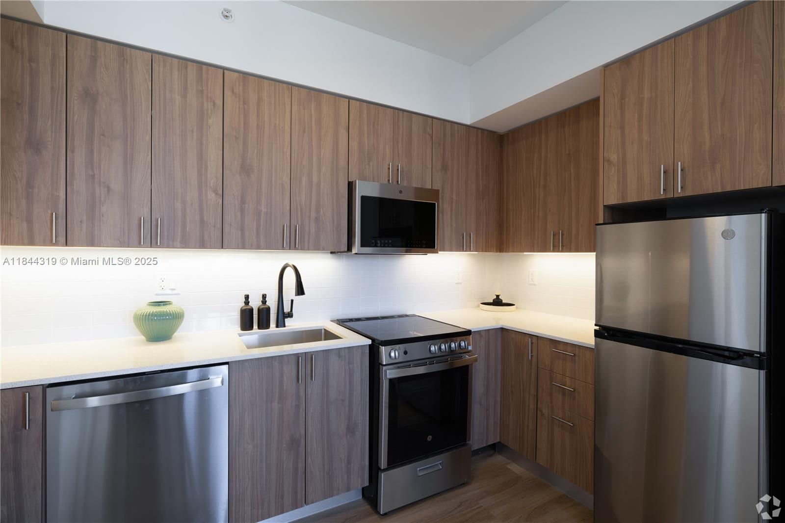 650 Southwest 1st Street, Unit 205 Miami, FL 33130 - Photo 4 of 15 a kitchen with a sink and a refrigerator