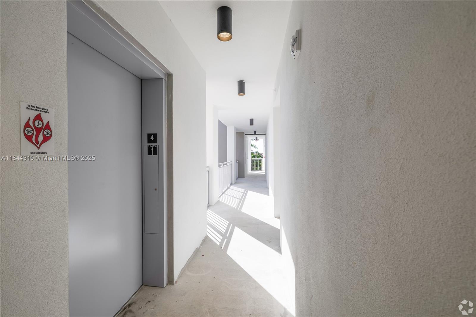 650 Southwest 1st Street, Unit 205 Miami, FL 33130 - Photo 9 of 15 a view of a hallway with white walls and refrigerator