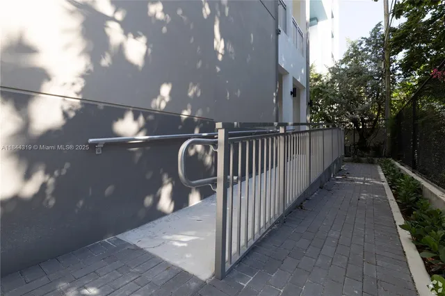 a front view of a building with a garden