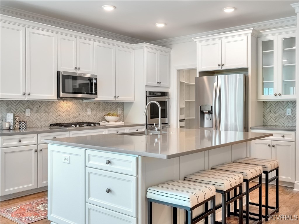 351 Swinburne Road Manakin-Sabot, VA 23103 - Photo 17 of 48 a kitchen with granite countertop white cabinets and stainless steel appliances