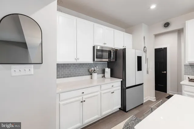 a kitchen with a refrigerator sink and cabinets