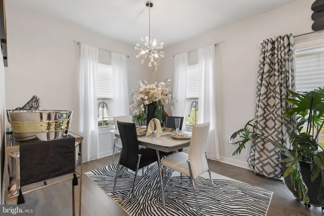 a view of a dining room with furniture and chandelier