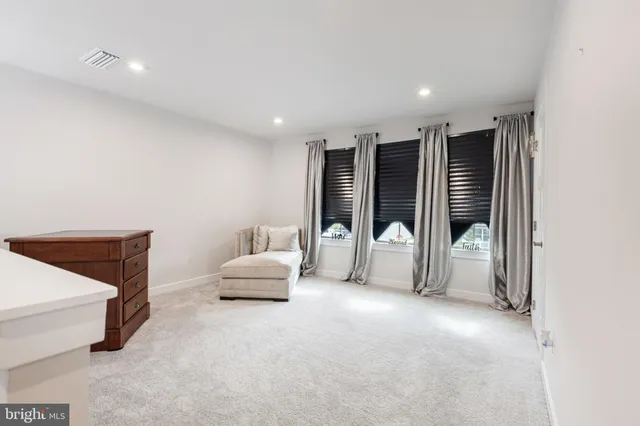 a living room with furniture and white walls