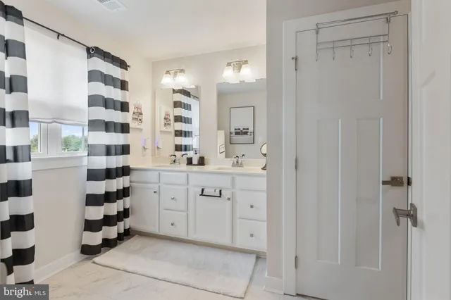 a spacious bathroom with a shower and a sink