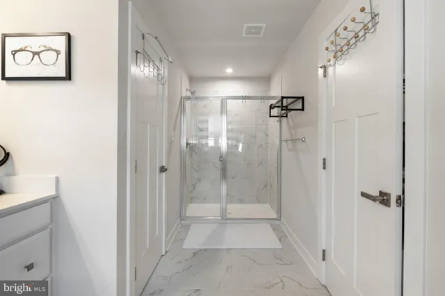 a bathroom with a glass shower door